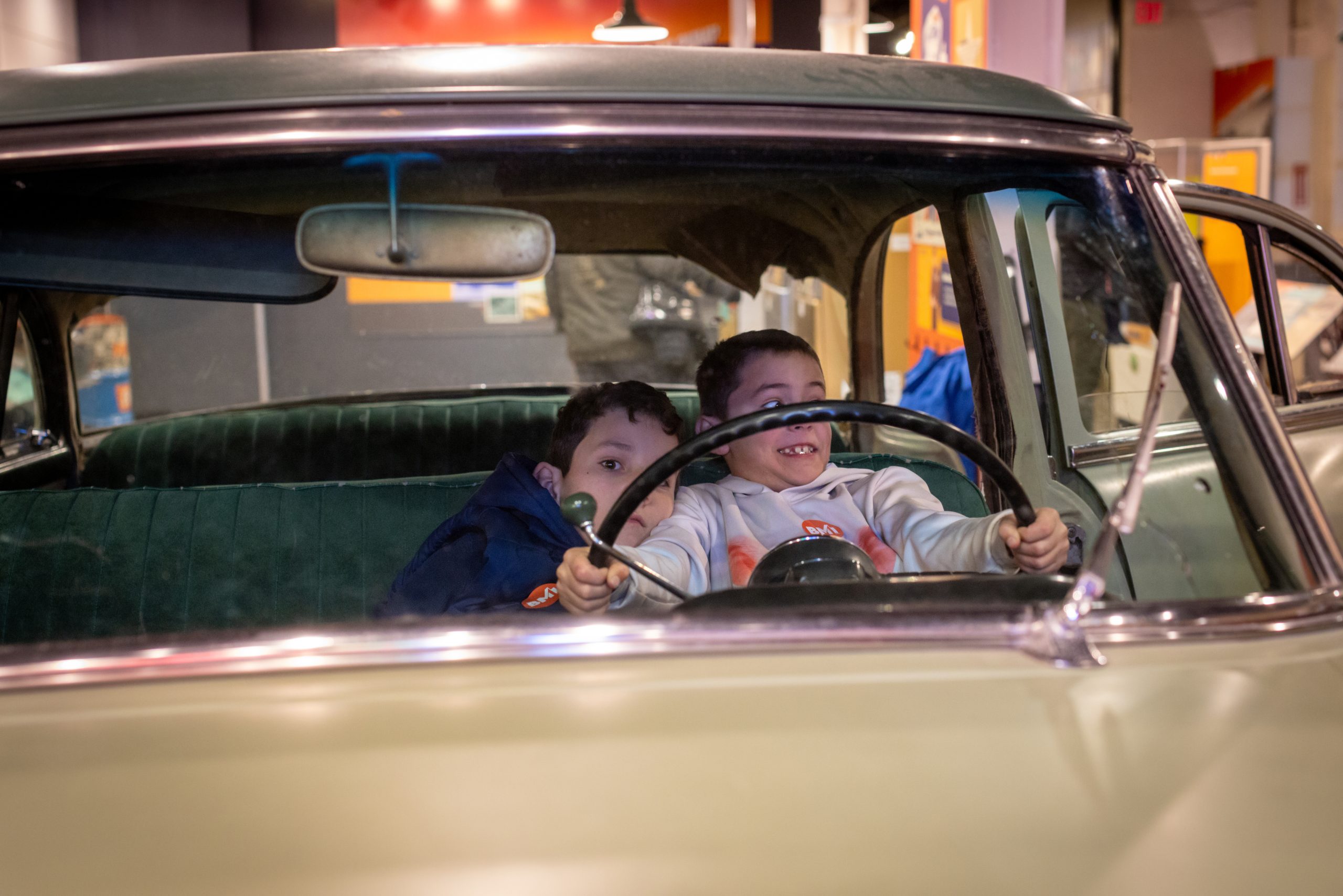 two boys in antique car