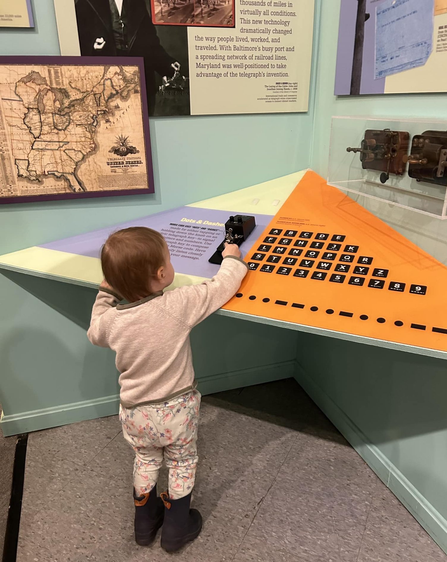 small child using telegraph at museum